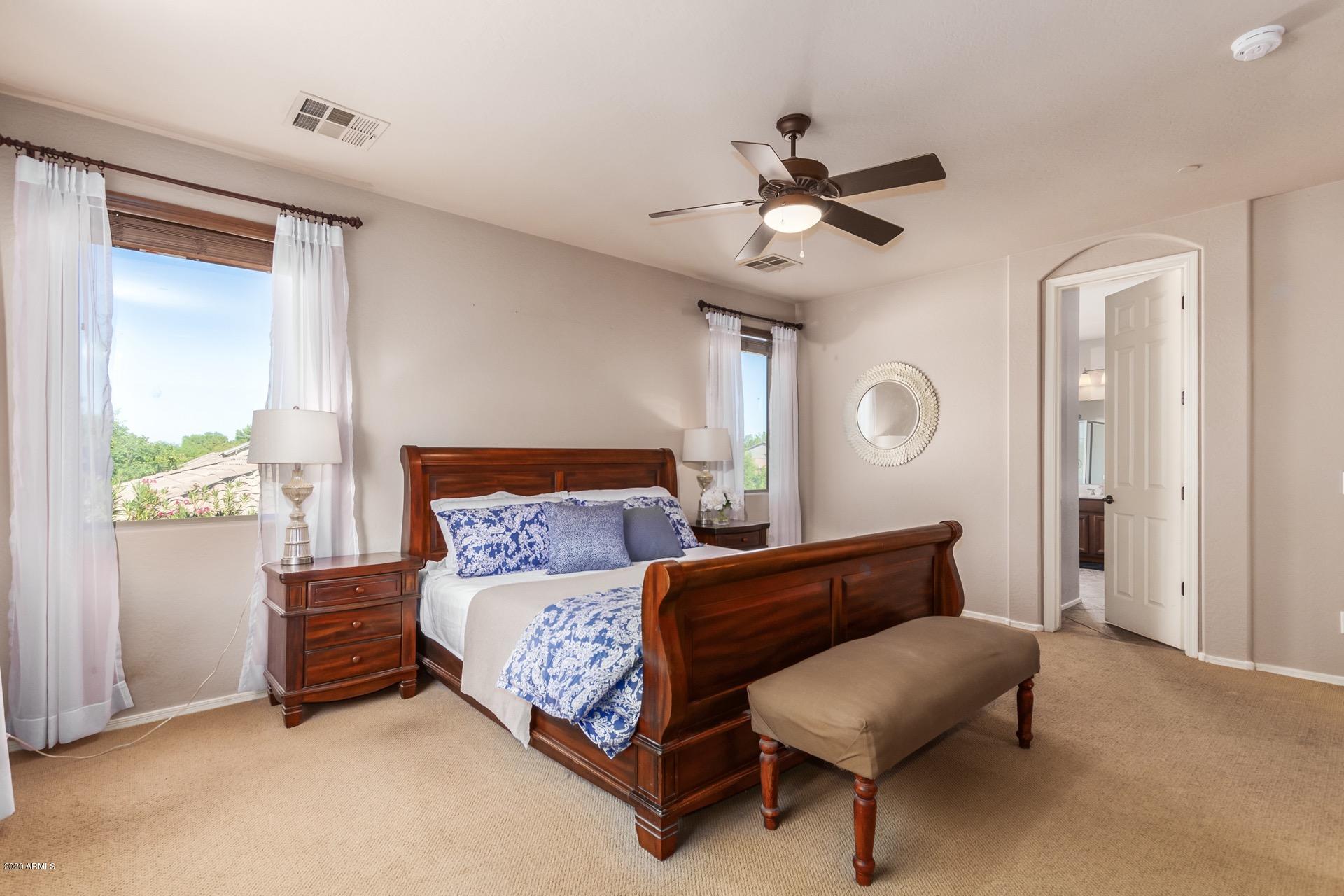 1043 Phelps Street Gilbert, AZ 85295 - Photo 7 of 18 a bedroom with a bed and a chandelier