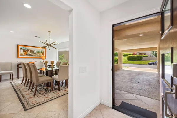 a living room with furniture tv and a large window