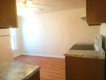 a view of kitchen and wooden floor