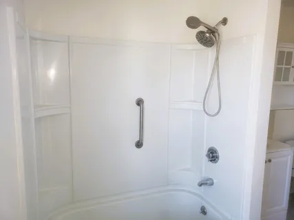a bathroom with a bath tub with a shower
