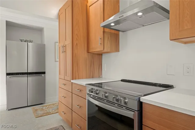 a kitchen with a stove and a refrigerator