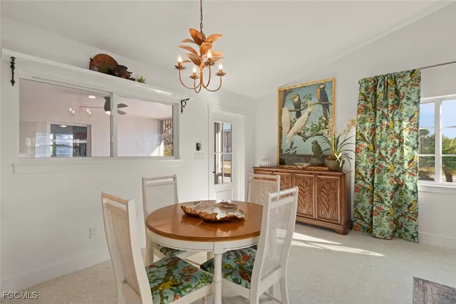 a view of a dining room with furniture and a chandelier