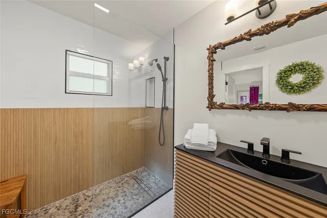 a bedroom with bed and wooden floor