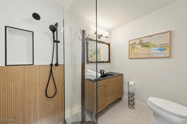 a bathroom with a toilet sink and shower