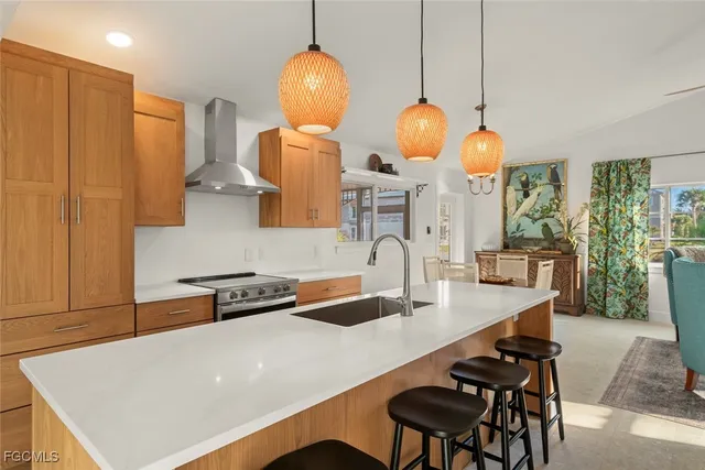 a kitchen with stainless steel appliances a table chairs and a refrigerator