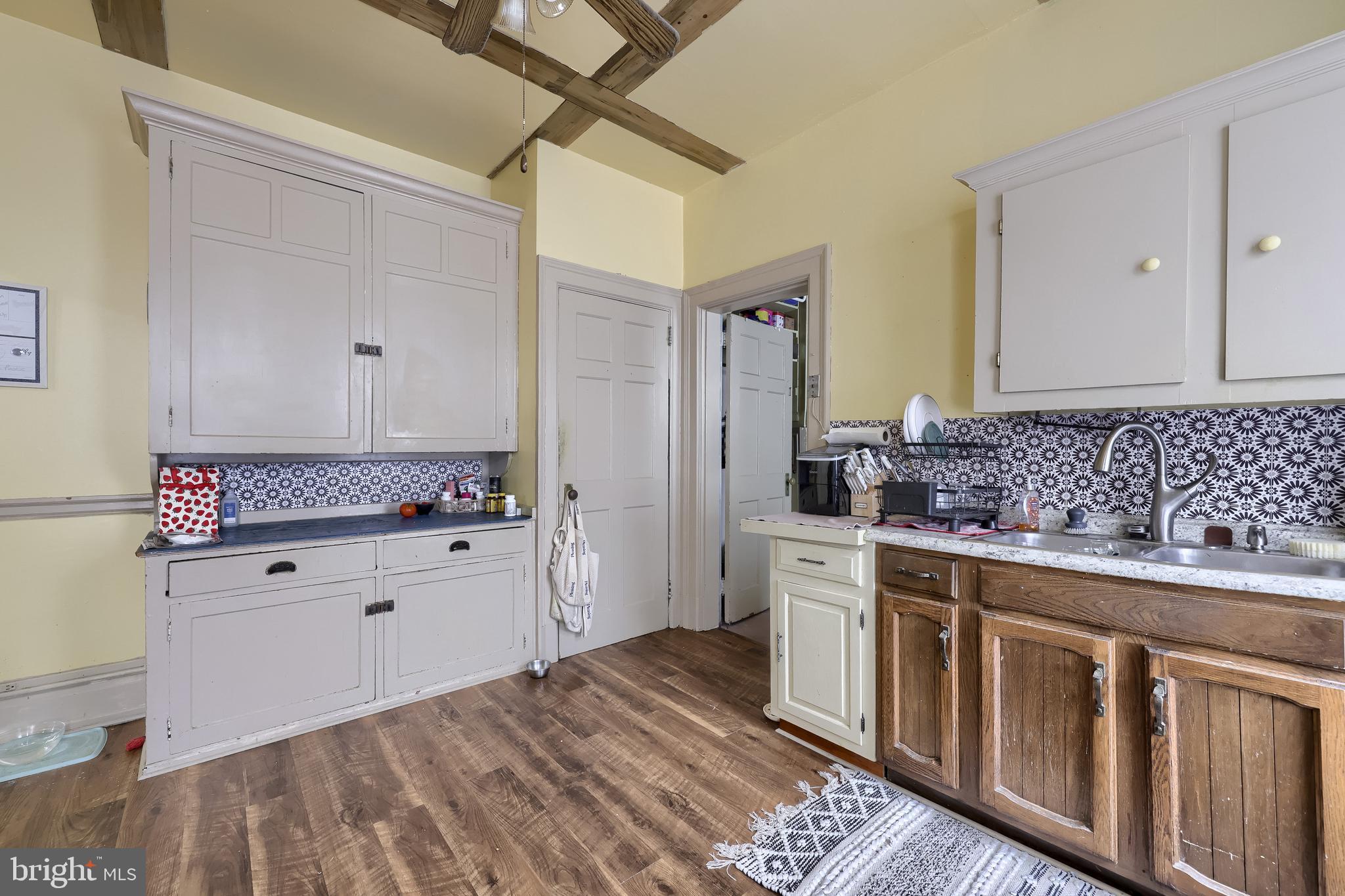 12 South Queen Street Lancaster, PA 17603 - Photo 35 of 58 a kitchen with granite countertop white cabinets and white appliances