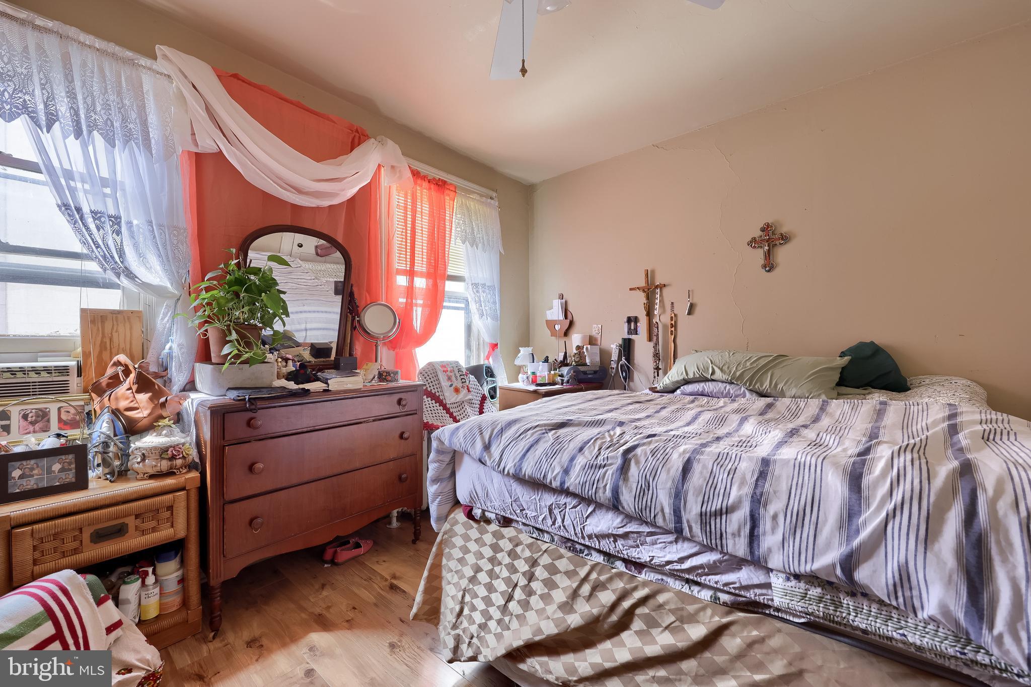12 South Queen Street Lancaster, PA 17603 - Photo 50 of 58 a bedroom with a bed mirror and a window