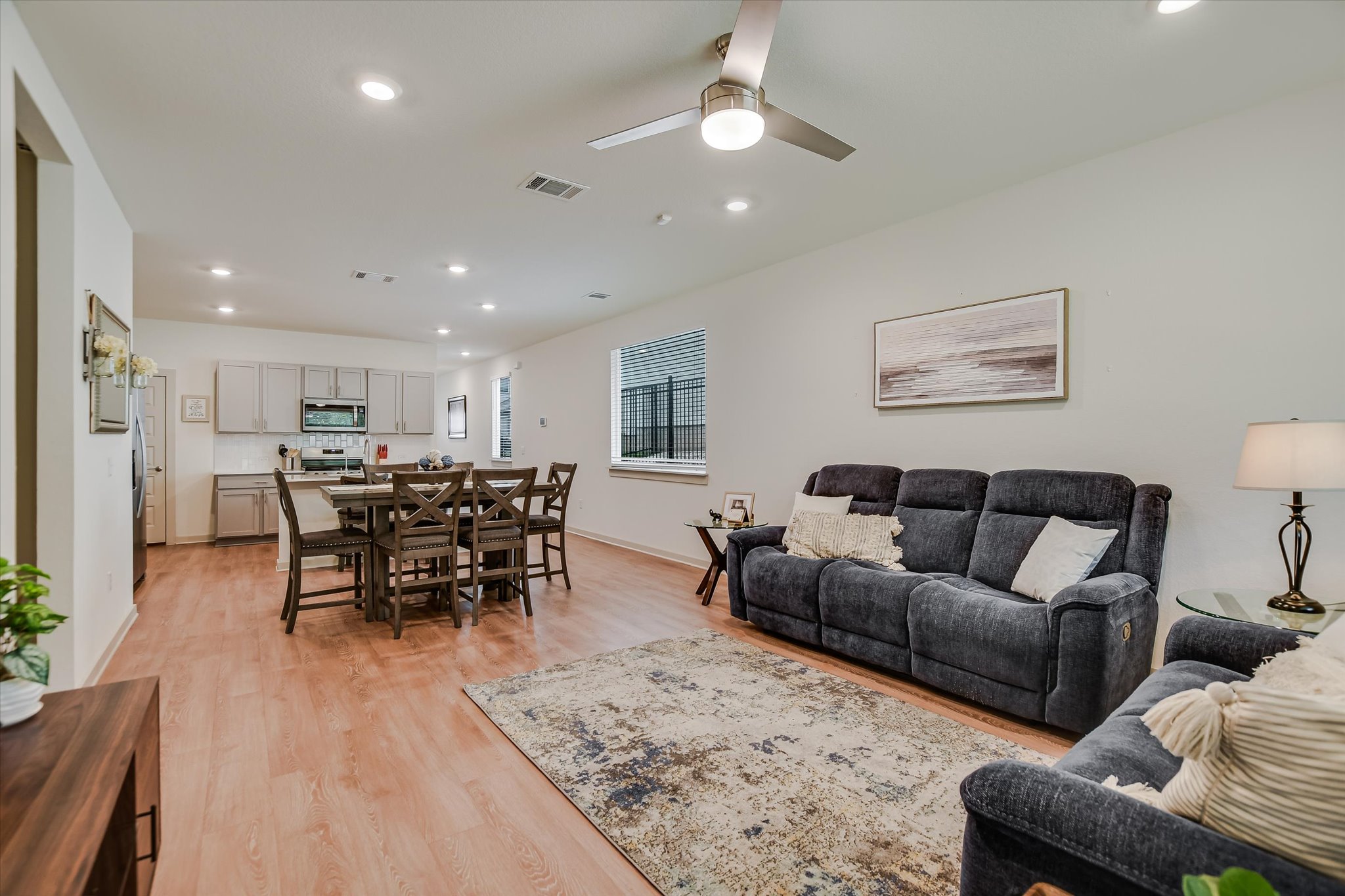 105 Merrick Road Georgetown, TX 78628 - Photo 7 of 23 An open concept living area features ample recessed lighting and durable wood flooring throughout.