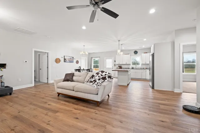 a living room with furniture and kitchen view