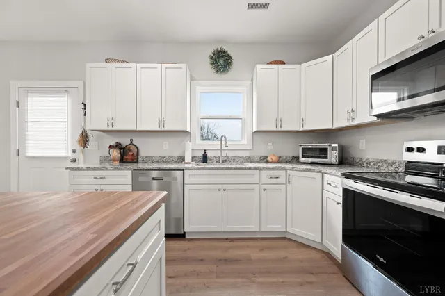 a kitchen with cabinets appliances and a window