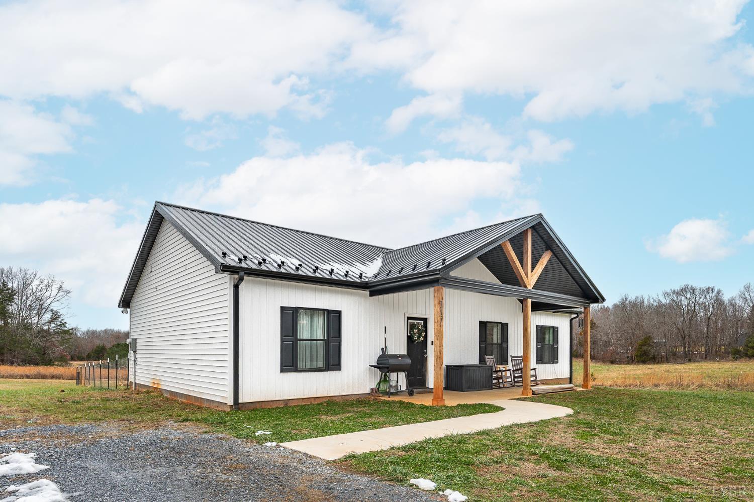 351 Down Creek Road Brookneal, VA 24528 - Photo 2 of 42 a front view of a house with a yard and garage