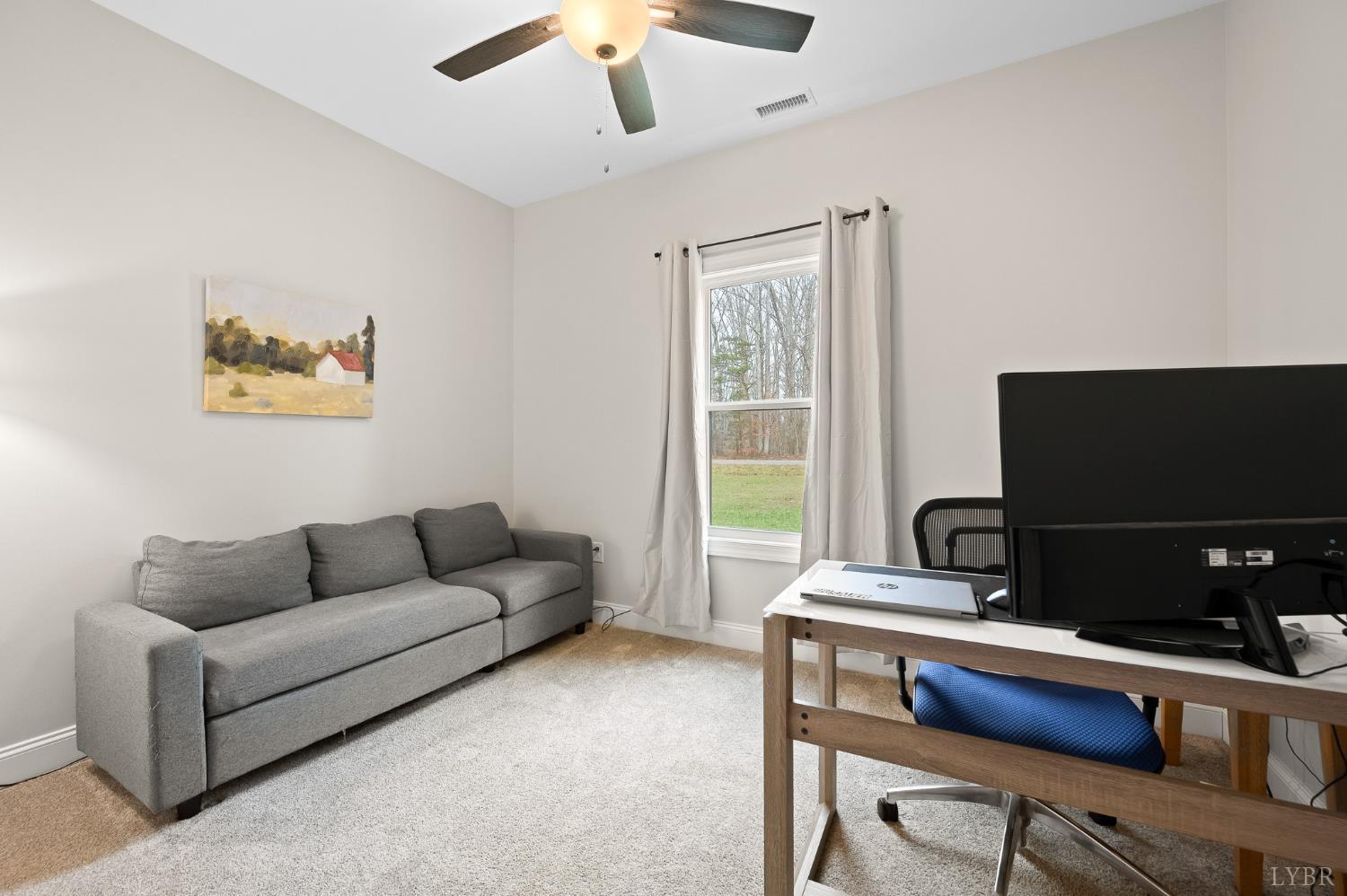351 Down Creek Road Brookneal, VA 24528 - Photo 24 of 42 a living room with furniture and a flat screen tv