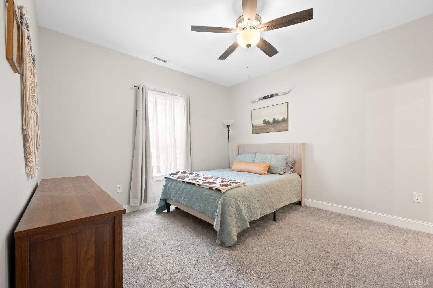 351 Down Creek Road Brookneal, VA 24528 - Photo 26 of 42 a bedroom with a bed and a chandelier