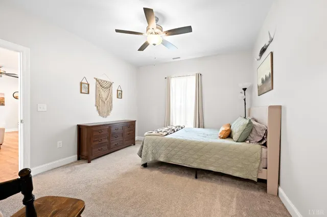 a bedroom with a bed couch and window