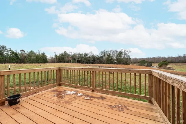 a view of balcony with wooden floor and fence