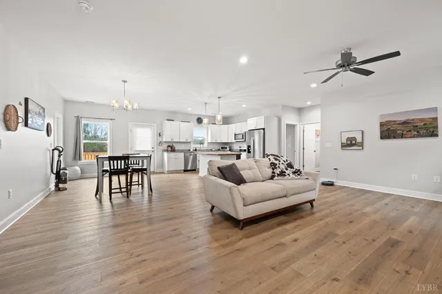a living room with furniture and kitchen view