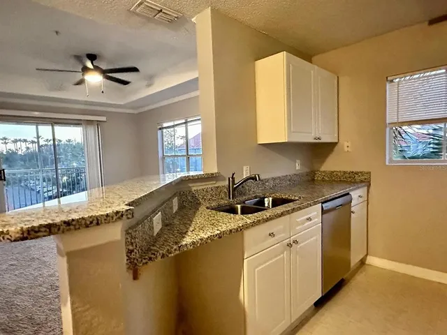 a kitchen with granite countertop cabinets stainless steel appliances and a granite counter tops