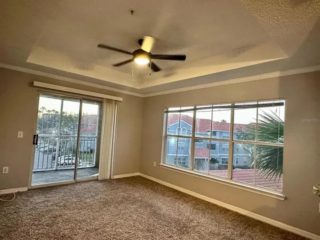 a view of room with window and ceiling fan