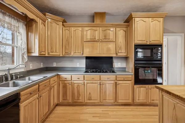 a kitchen with stainless steel appliances granite countertop a stove and a sink