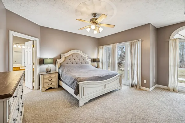 a bedroom with a bed and a chandelier
