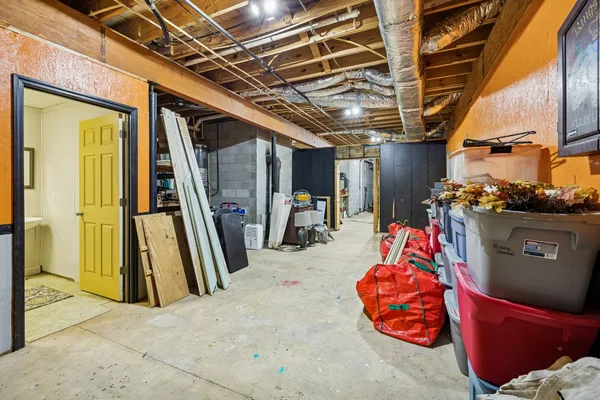 a view of a storage room with a sink and a refrigerator