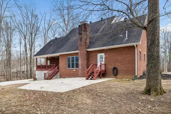 a view of a house with a yard covered in snow