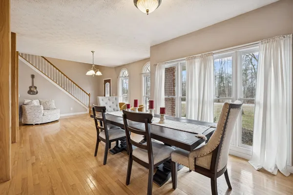 a dining room with furniture and window