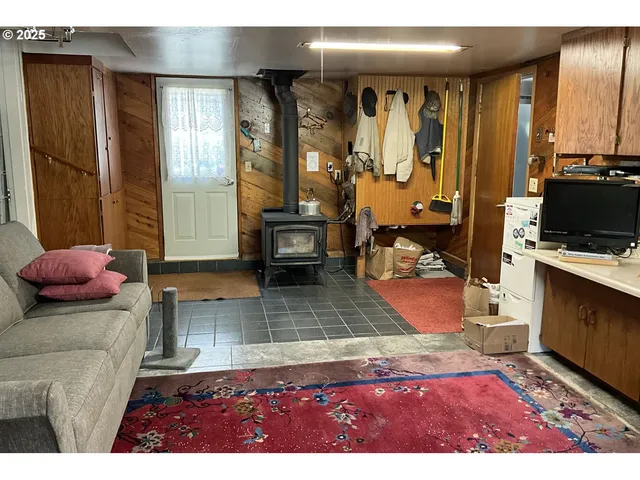 a view of living room filled with furniture and a fireplace