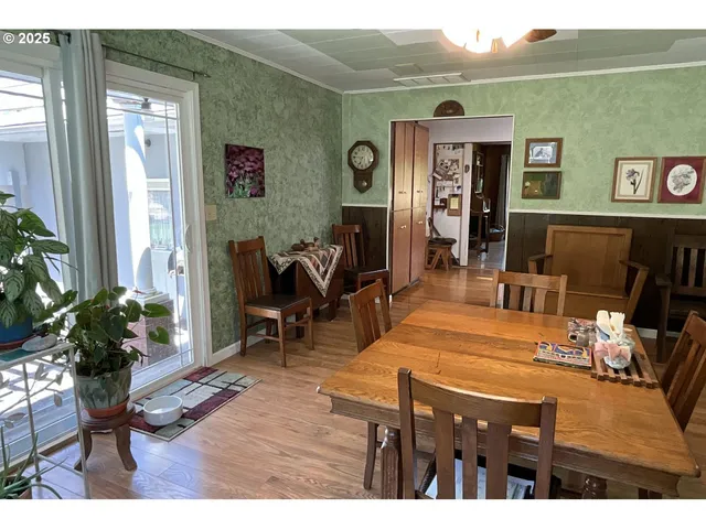 a living room with furniture a potted plant and a large window