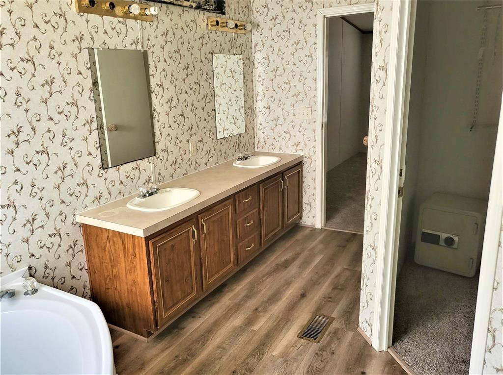 14536 Cochran Road Waller, TX 77484 - Photo 11 of 14 a bathroom with a double vanity sink and mirror