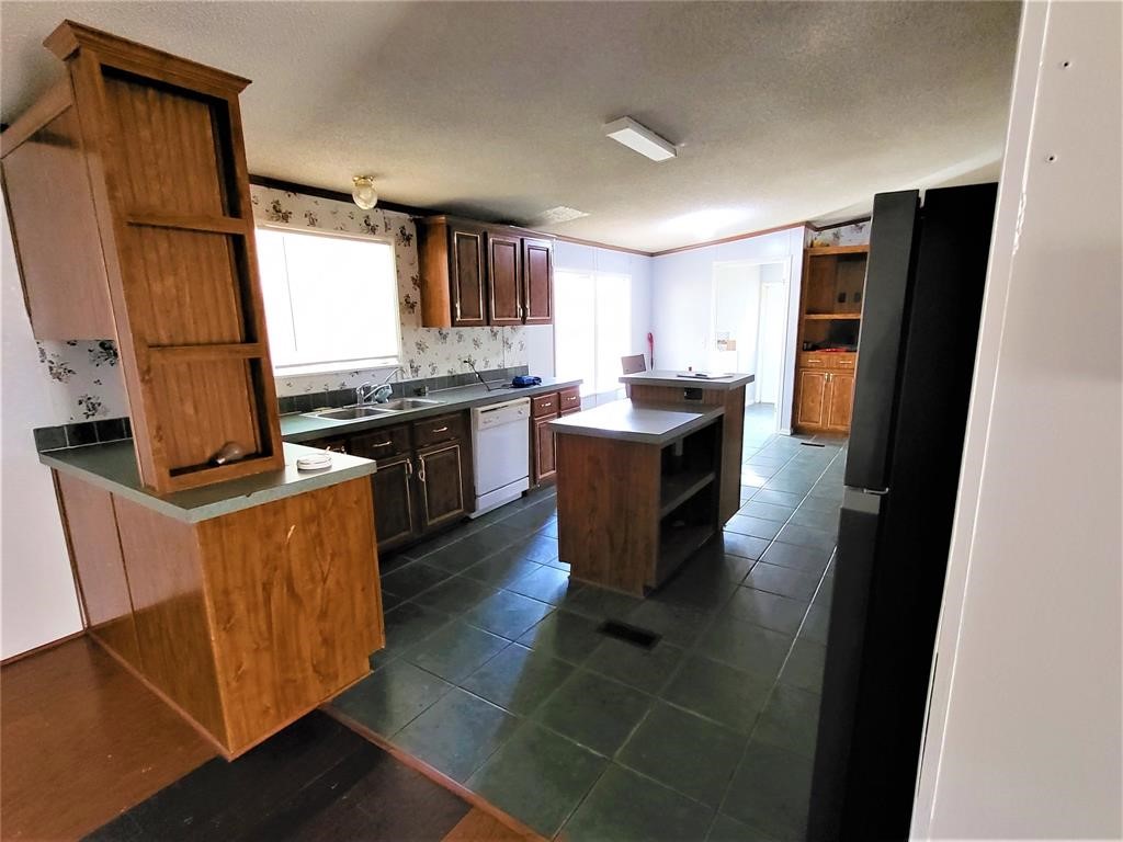 14536 Cochran Road Waller, TX 77484 - Photo 7 of 14 a kitchen with stainless steel appliances granite countertop a refrigerator a stove a sink dishwasher and a refrigerator