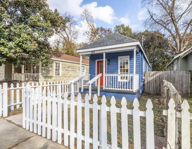 a view of a house with wooden fence