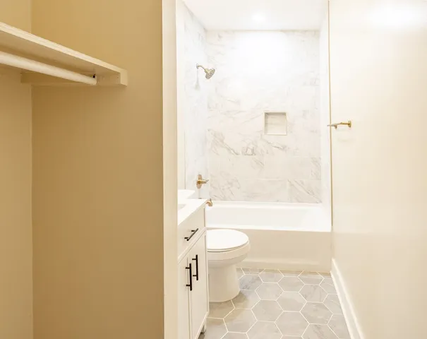 a bathroom with a toilet and a shower