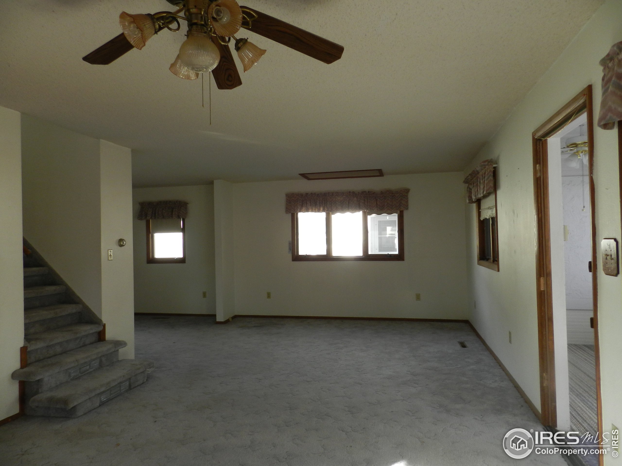 827 Prospect Street Fort Morgan, CO 80701 - Photo 6 of 19 a view of an empty room with a window