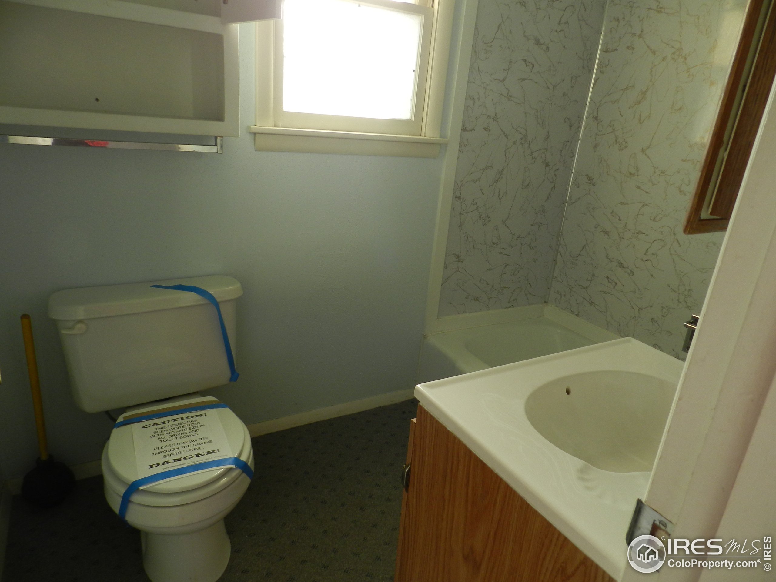 827 Prospect Street Fort Morgan, CO 80701 - Photo 9 of 19 a bathroom with a sink and a toilet