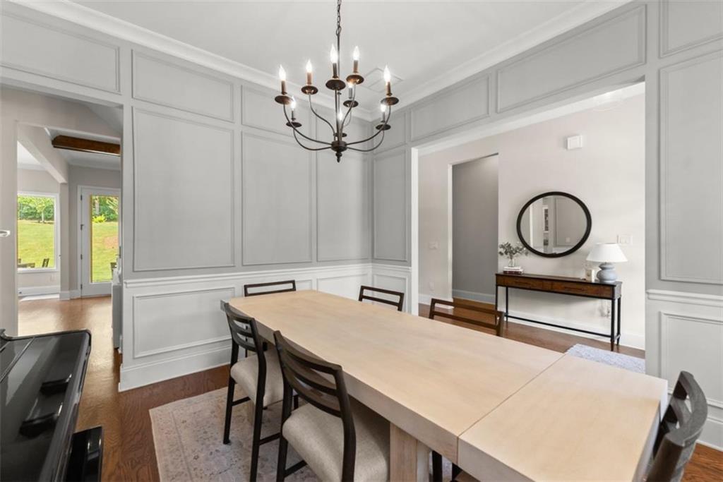 845 Walnut River Trail Hoschton, GA 30548 - Photo 12 of 74 a view of a dining room with furniture and a chandelier