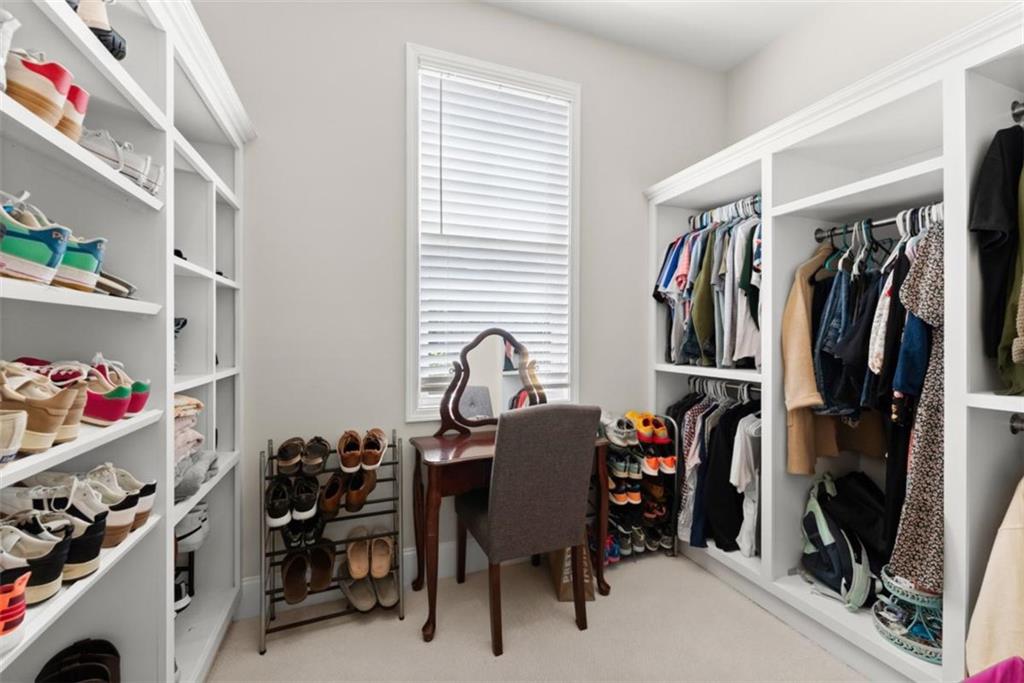 845 Walnut River Trail Hoschton, GA 30548 - Photo 22 of 74 a view of walk in closet with clothes and shoes