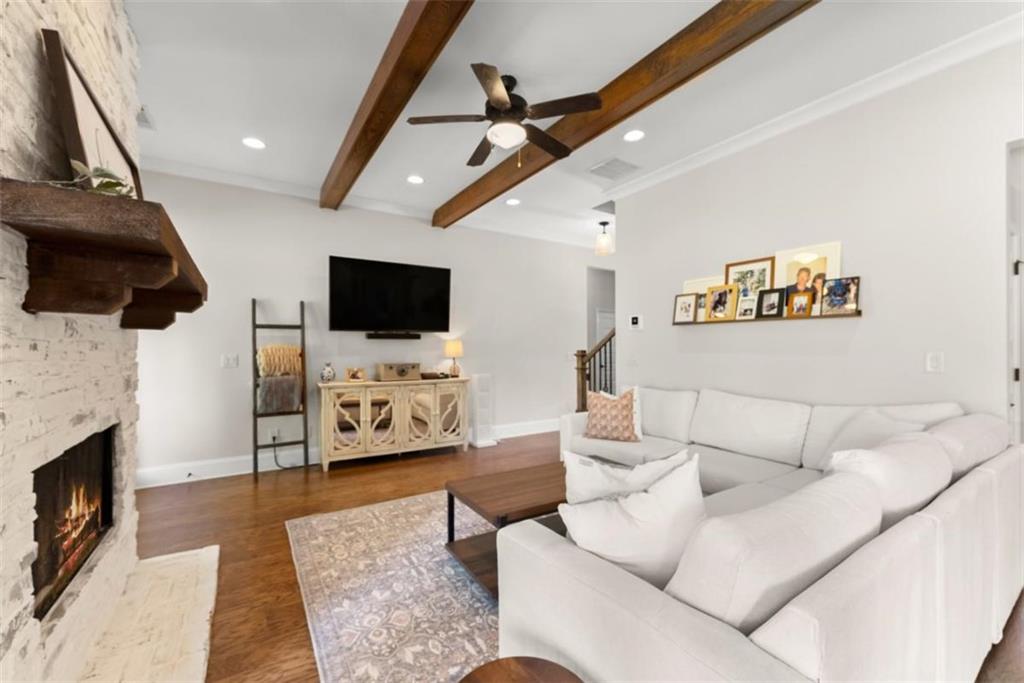 845 Walnut River Trail Hoschton, GA 30548 - Photo 24 of 74 a living room with furniture and a flat screen tv