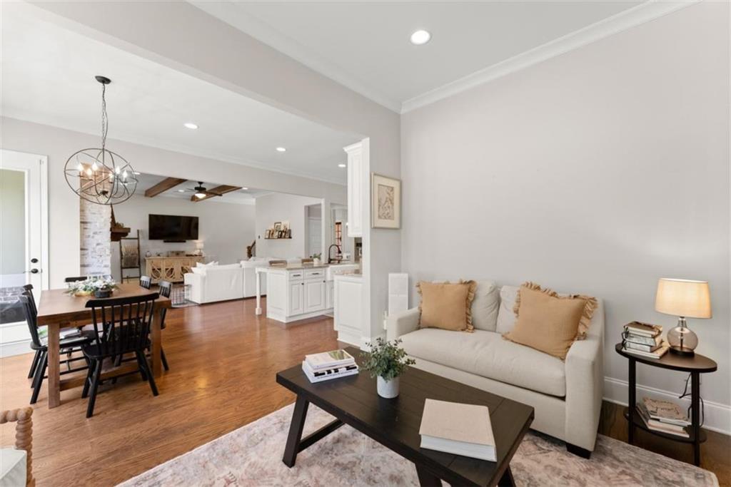 845 Walnut River Trail Hoschton, GA 30548 - Photo 28 of 74 a living room with furniture a table and chairs