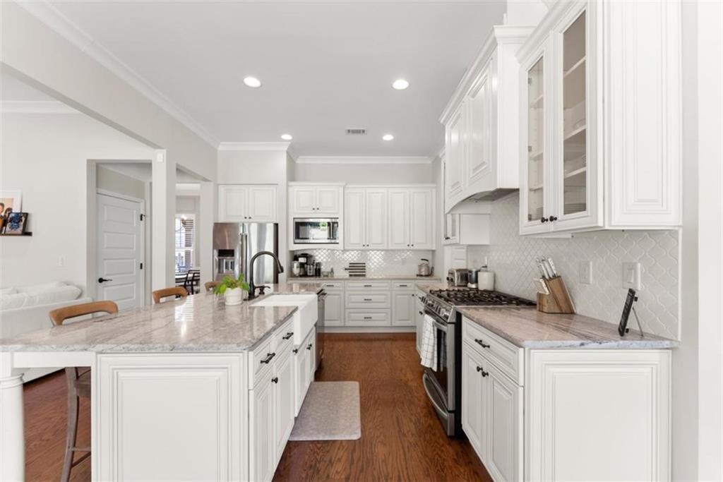 845 Walnut River Trail Hoschton, GA 30548 - Photo 33 of 74 a kitchen with stainless steel appliances a sink stove and cabinets