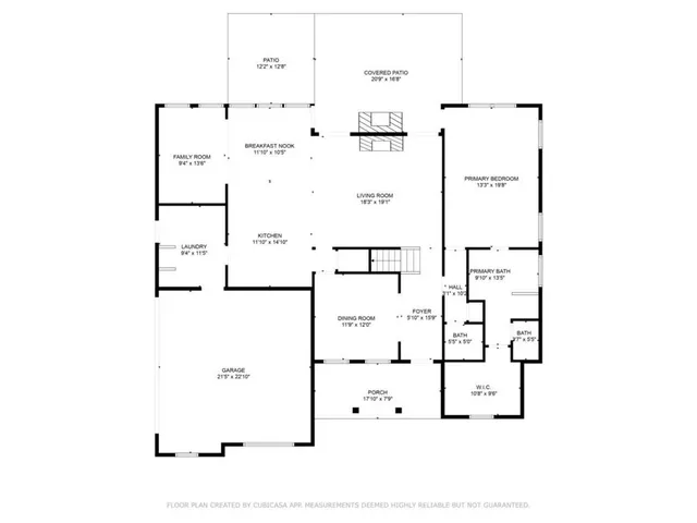 a bedroom with a bed and a lamp on the dresser