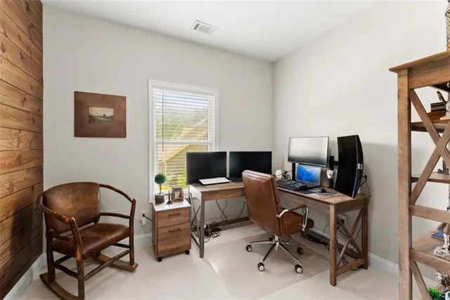 a living room with patio furniture and a fireplace