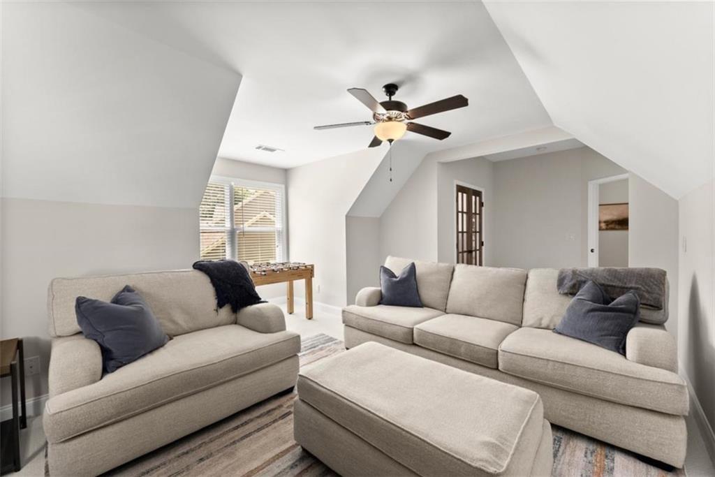 845 Walnut River Trail Hoschton, GA 30548 - Photo 37 of 74 a living room with furniture and a ceiling fan