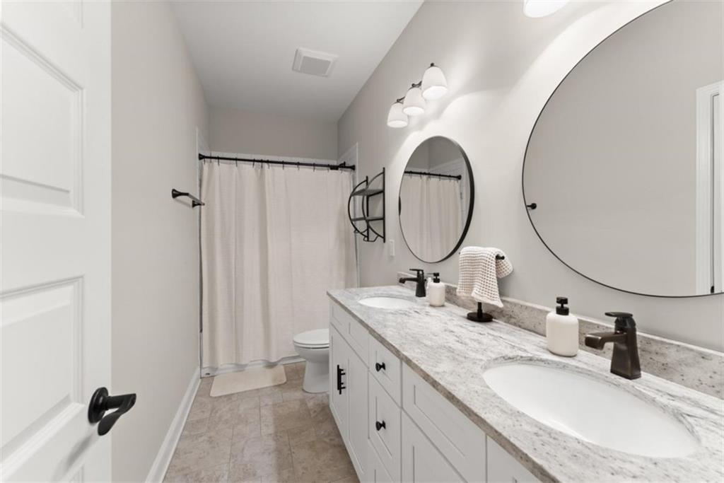 845 Walnut River Trail Hoschton, GA 30548 - Photo 42 of 74 a bathroom with a granite countertop double vanity sink and a mirror