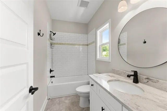 an aerial view of residential houses with outdoor space and trees