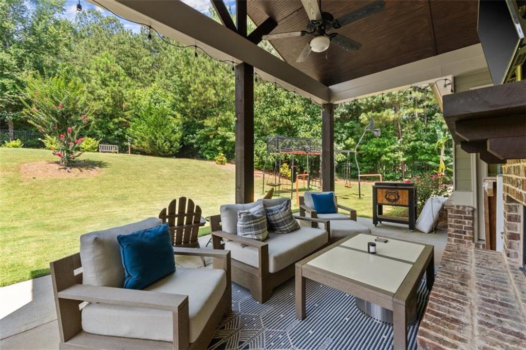 845 Walnut River Trail Hoschton, GA 30548 - Photo 51 of 74 a living room with patio furniture and a fireplace