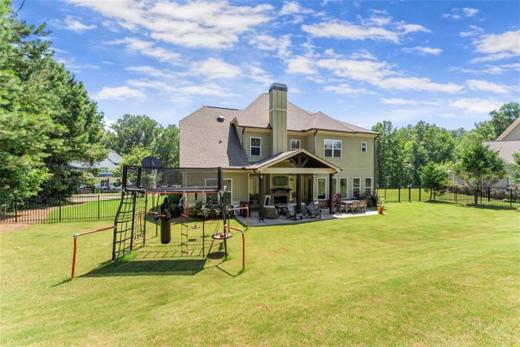 845 Walnut River Trail Hoschton, GA 30548 - Photo 57 of 74 a view of a house with swimming pool and sitting area
