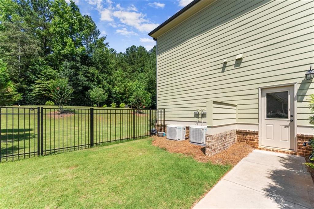 845 Walnut River Trail Hoschton, GA 30548 - Photo 60 of 74 a view of a house with a backyard
