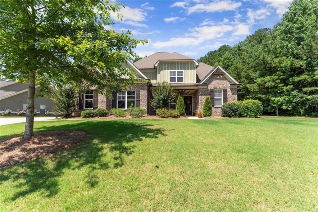 845 Walnut River Trail Hoschton, GA 30548 - Photo 8 of 74 a front view of a house with a yard