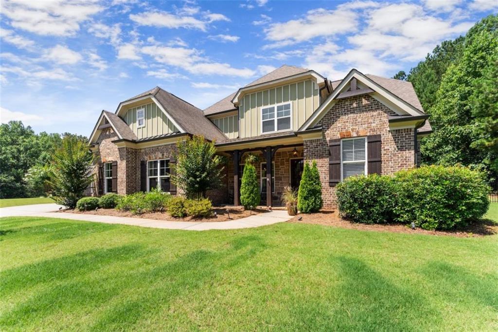 845 Walnut River Trail Hoschton, GA 30548 - Photo 9 of 74 a front view of a house with a yard